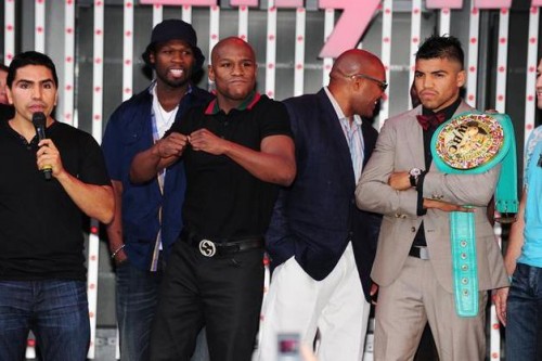 Floyd Mayweather (3L) gestures as he tak